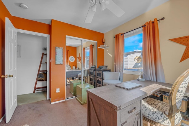 office featuring light carpet and a ceiling fan