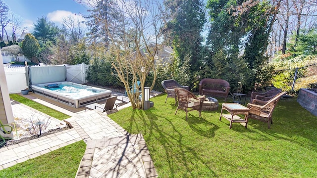 view of yard with a hot tub, an outdoor hangout area, a fenced backyard, and a patio