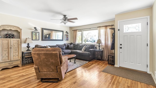 living area featuring a ceiling fan and light wood-type flooring