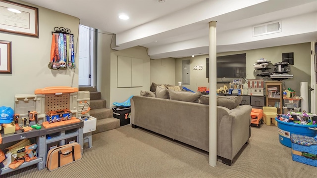 carpeted living room featuring visible vents and stairway