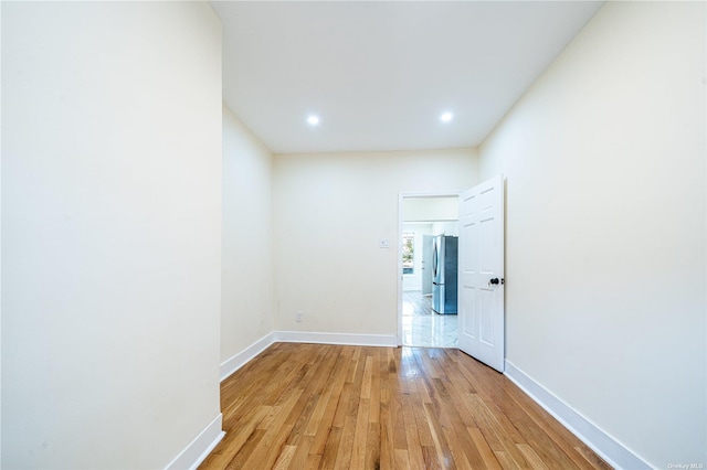 empty room featuring light wood-style floors and baseboards