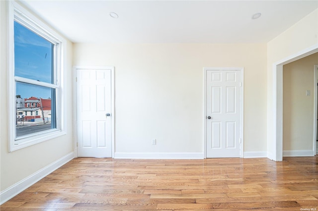 empty room featuring light wood-style flooring and baseboards