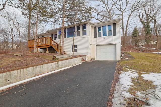 view of front of home with a garage, driveway, and stairway