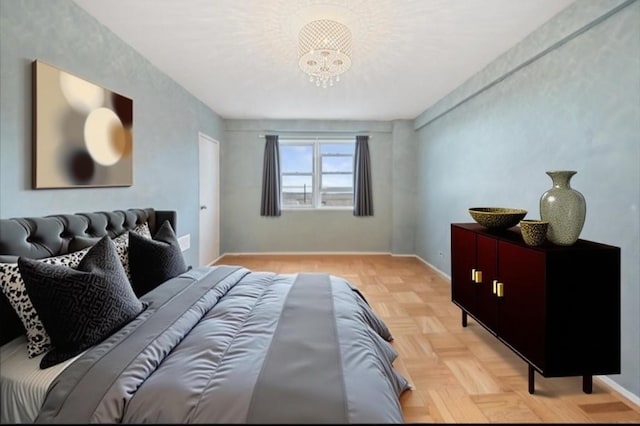 bedroom with a notable chandelier and baseboards