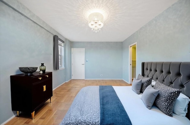 bedroom featuring a chandelier, parquet floors, and baseboards