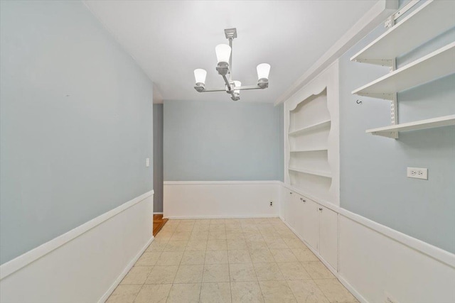 unfurnished dining area featuring light floors and a notable chandelier