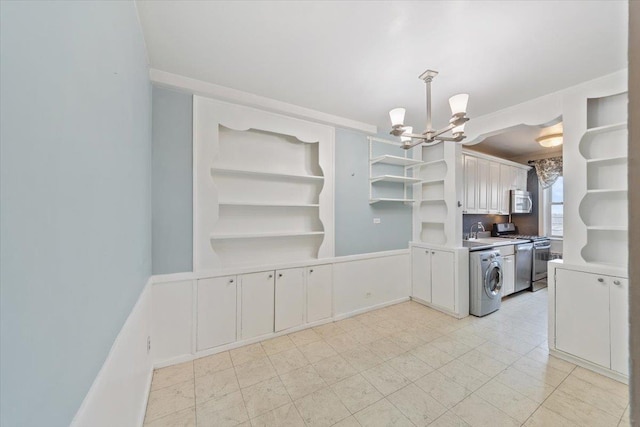 kitchen featuring open shelves, washer / clothes dryer, stainless steel appliances, and white cabinets