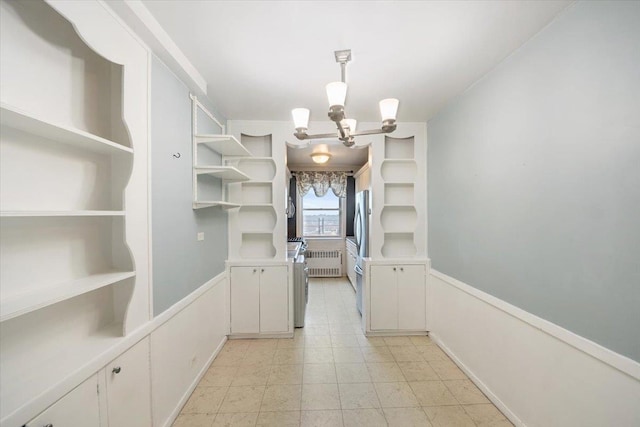 walk in closet featuring a notable chandelier