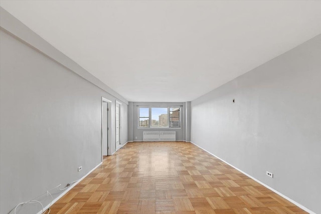 spare room featuring radiator heating unit