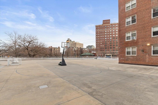 view of basketball court featuring community basketball court and fence