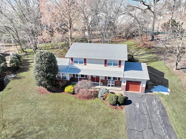 view of front of property featuring driveway, a garage, a shingled roof, a porch, and a front lawn