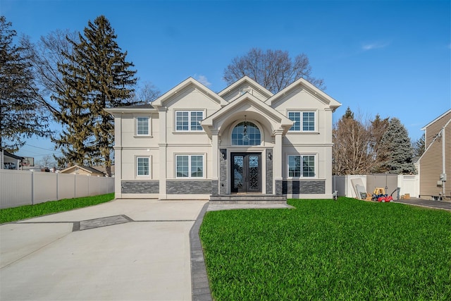 view of front of house featuring stone siding, french doors, fence, and stucco siding