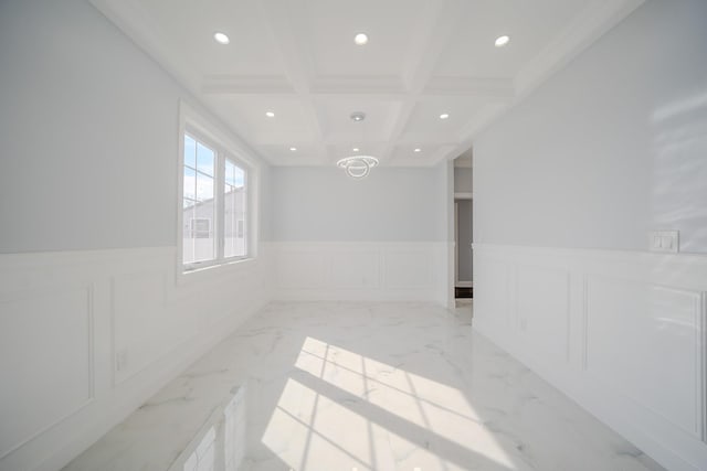unfurnished room featuring recessed lighting, a wainscoted wall, coffered ceiling, marble finish floor, and beam ceiling