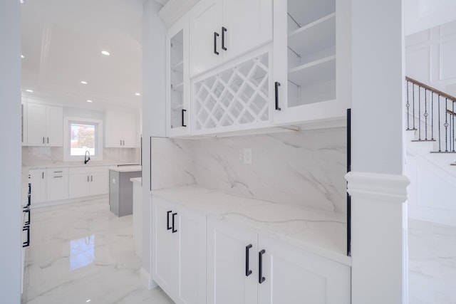 bar with decorative backsplash, marble finish floor, stairs, a sink, and recessed lighting