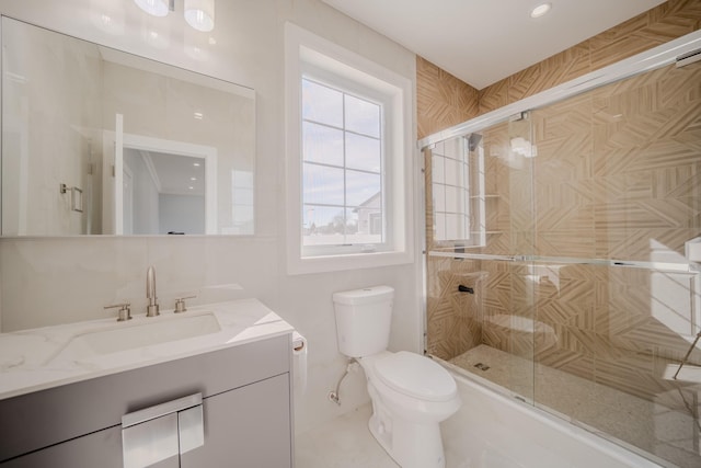 bathroom with vanity, toilet, and a shower stall
