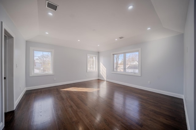 unfurnished room with baseboards, a raised ceiling, wood finished floors, and recessed lighting