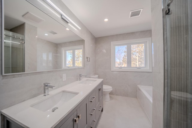 full bathroom featuring visible vents, tile walls, and a sink