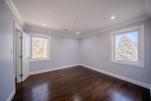 spare room featuring dark wood-style floors, baseboards, and ornamental molding
