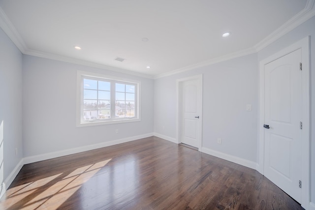 unfurnished room featuring dark wood-style floors, crown molding, and baseboards