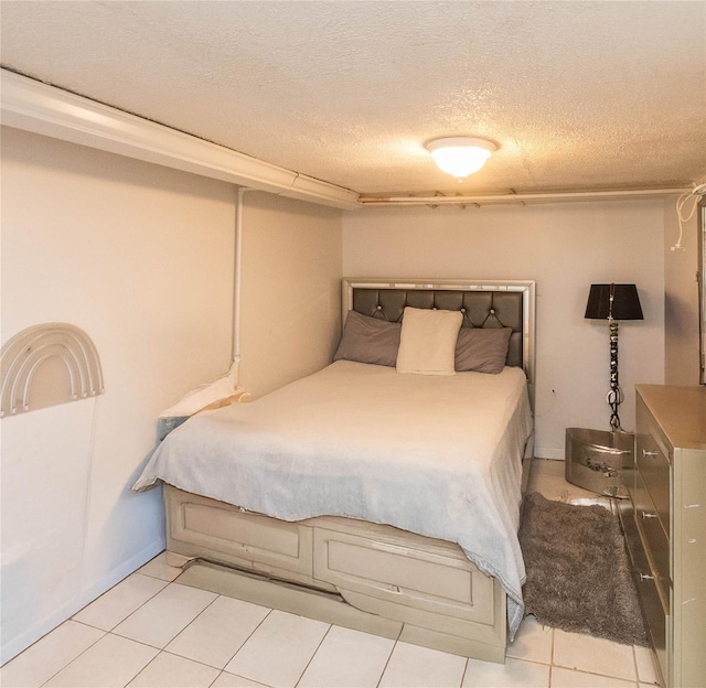 bedroom featuring light tile patterned flooring and a textured ceiling