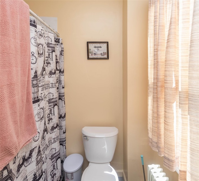 bathroom with toilet and curtained shower