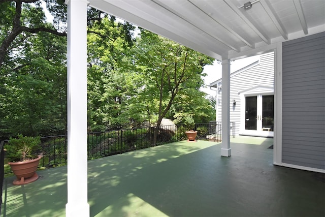 view of patio featuring french doors and fence