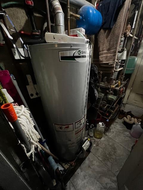 utility room featuring water heater