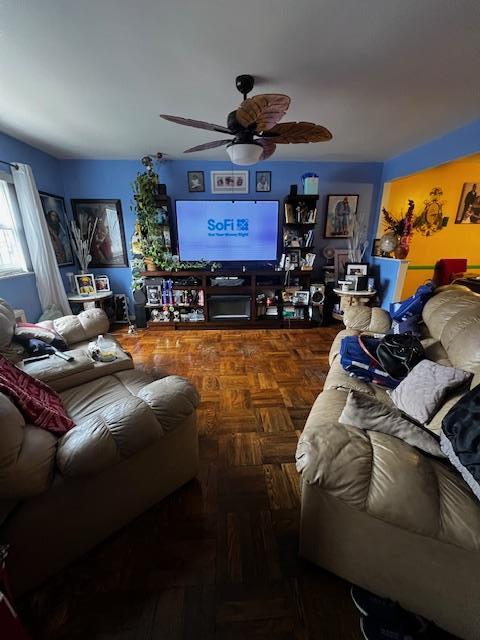 living area with a ceiling fan