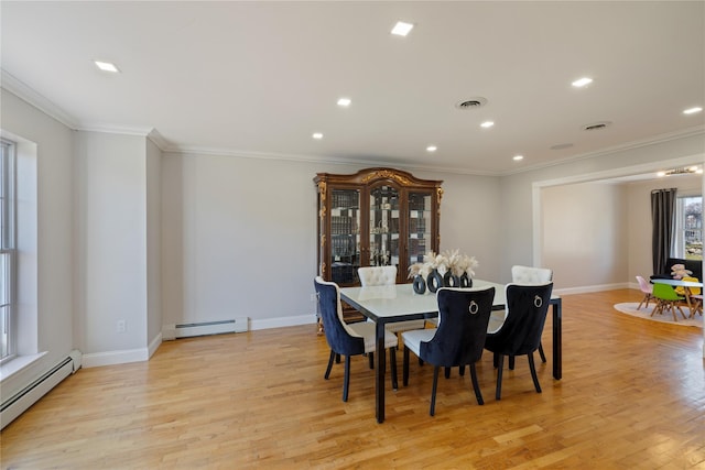 dining space featuring light wood-style flooring, baseboard heating, and visible vents