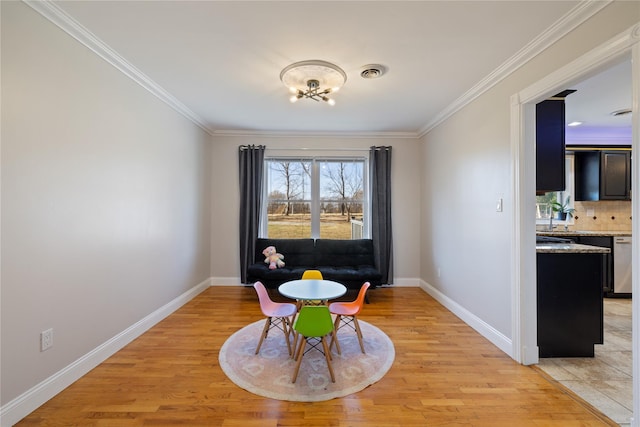 dining area featuring baseboards, ornamental molding, visible vents, and light wood-style floors