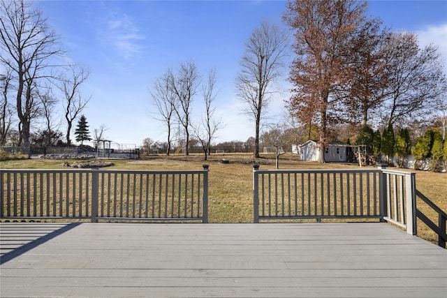 deck featuring a yard and an outdoor structure