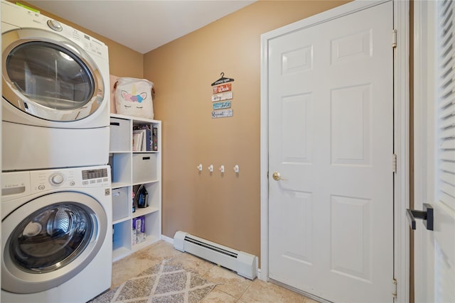 laundry area with a baseboard radiator, tile patterned flooring, laundry area, baseboards, and stacked washing maching and dryer