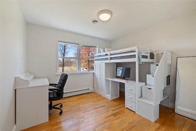 bedroom with light wood-style flooring, a baseboard radiator, and visible vents