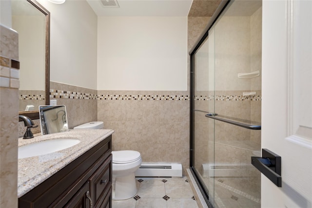 full bathroom featuring toilet, tile patterned floors, baseboard heating, a shower stall, and tile walls