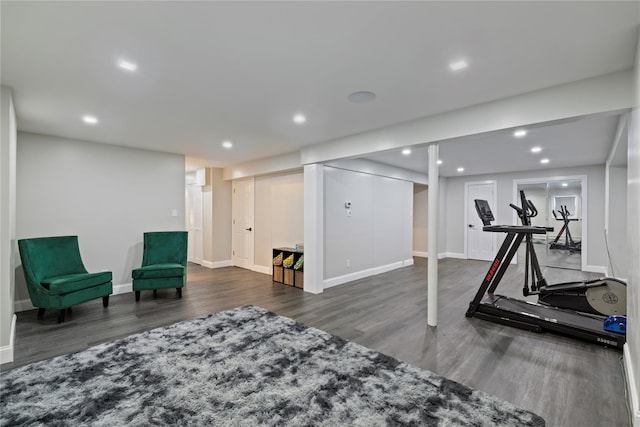 workout room with baseboards, wood finished floors, and recessed lighting