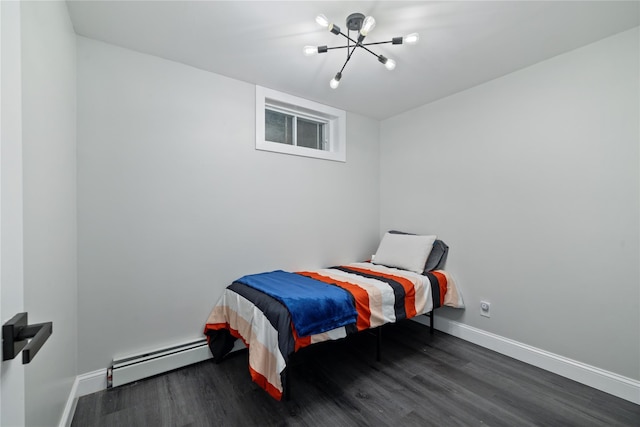 bedroom featuring baseboards, a baseboard heating unit, and wood finished floors