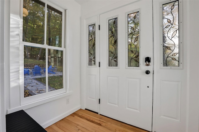 entryway with light wood-style flooring and baseboards