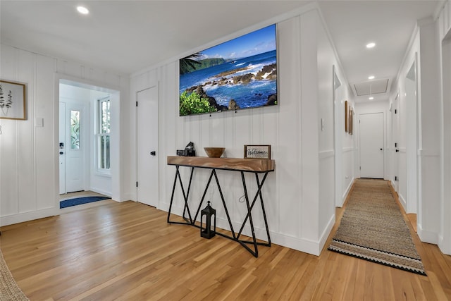 foyer entrance with light wood-style floors, recessed lighting, a decorative wall, and baseboards