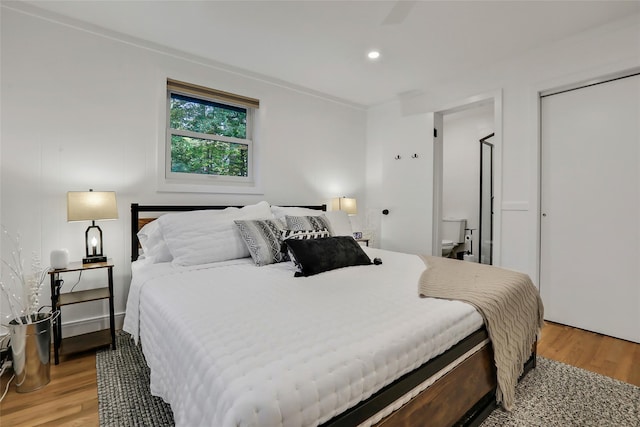 bedroom with recessed lighting and light wood-style flooring