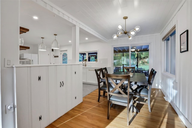 dining space with a chandelier, light wood-type flooring, and recessed lighting