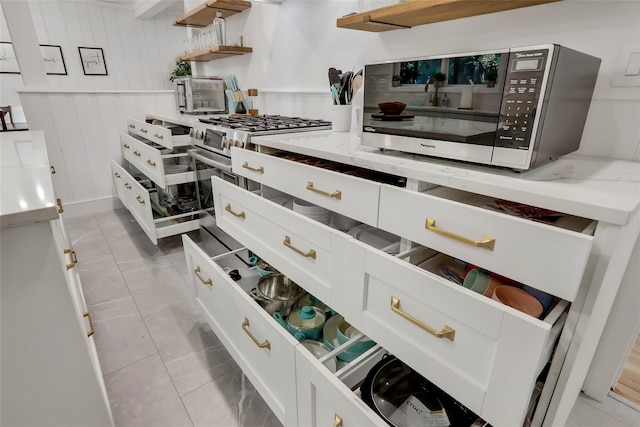 kitchen featuring light tile patterned floors and open shelves