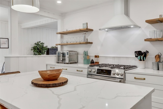 kitchen with a toaster, white cabinets, gas range, premium range hood, and open shelves