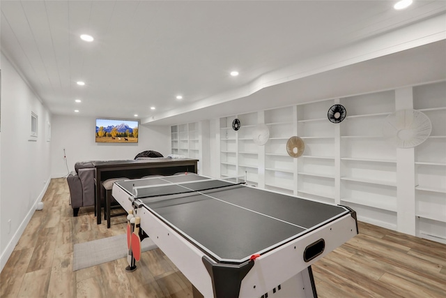 playroom with baseboards, built in shelves, wood finished floors, and recessed lighting