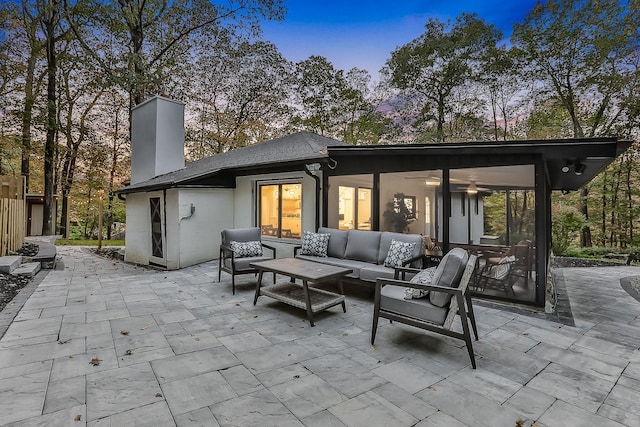 view of patio / terrace featuring a ceiling fan, a sunroom, and an outdoor hangout area