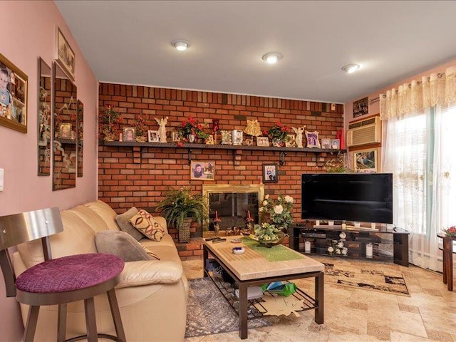 living area featuring brick wall, a fireplace, and a wealth of natural light