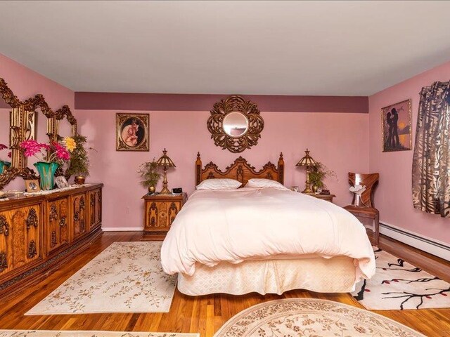 bedroom featuring baseboards and wood finished floors