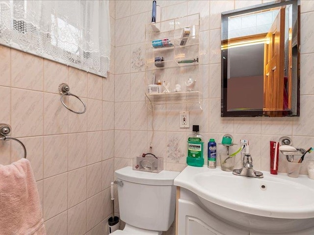 bathroom with decorative backsplash, vanity, toilet, and tile walls