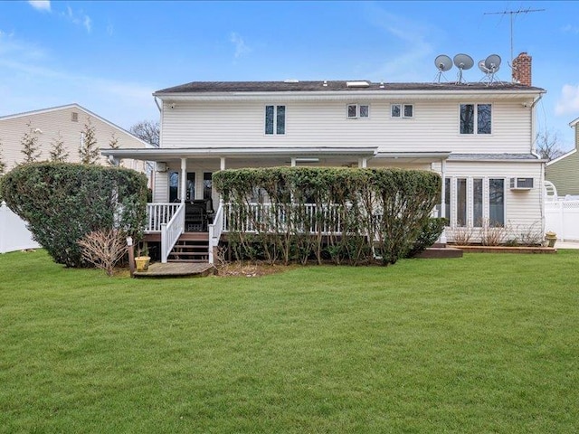 back of house with fence and a yard