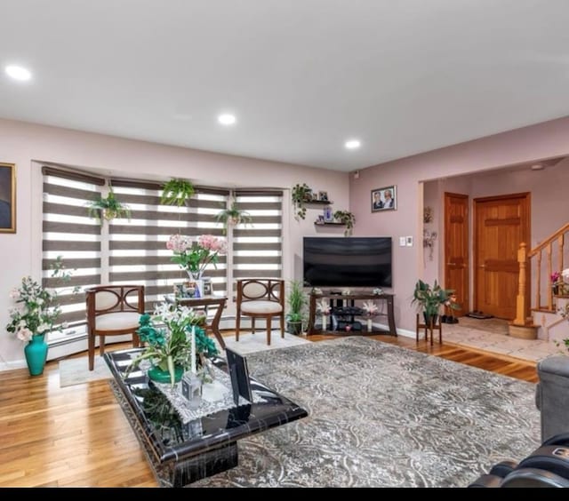 living area with stairs, baseboards, wood finished floors, and recessed lighting