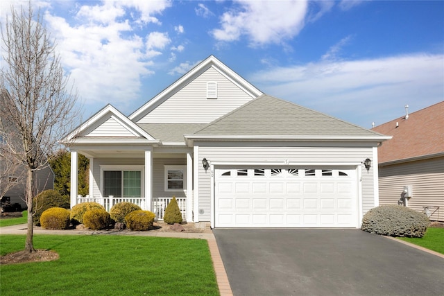 view of front facade featuring aphalt driveway, a garage, covered porch, roof with shingles, and a front yard